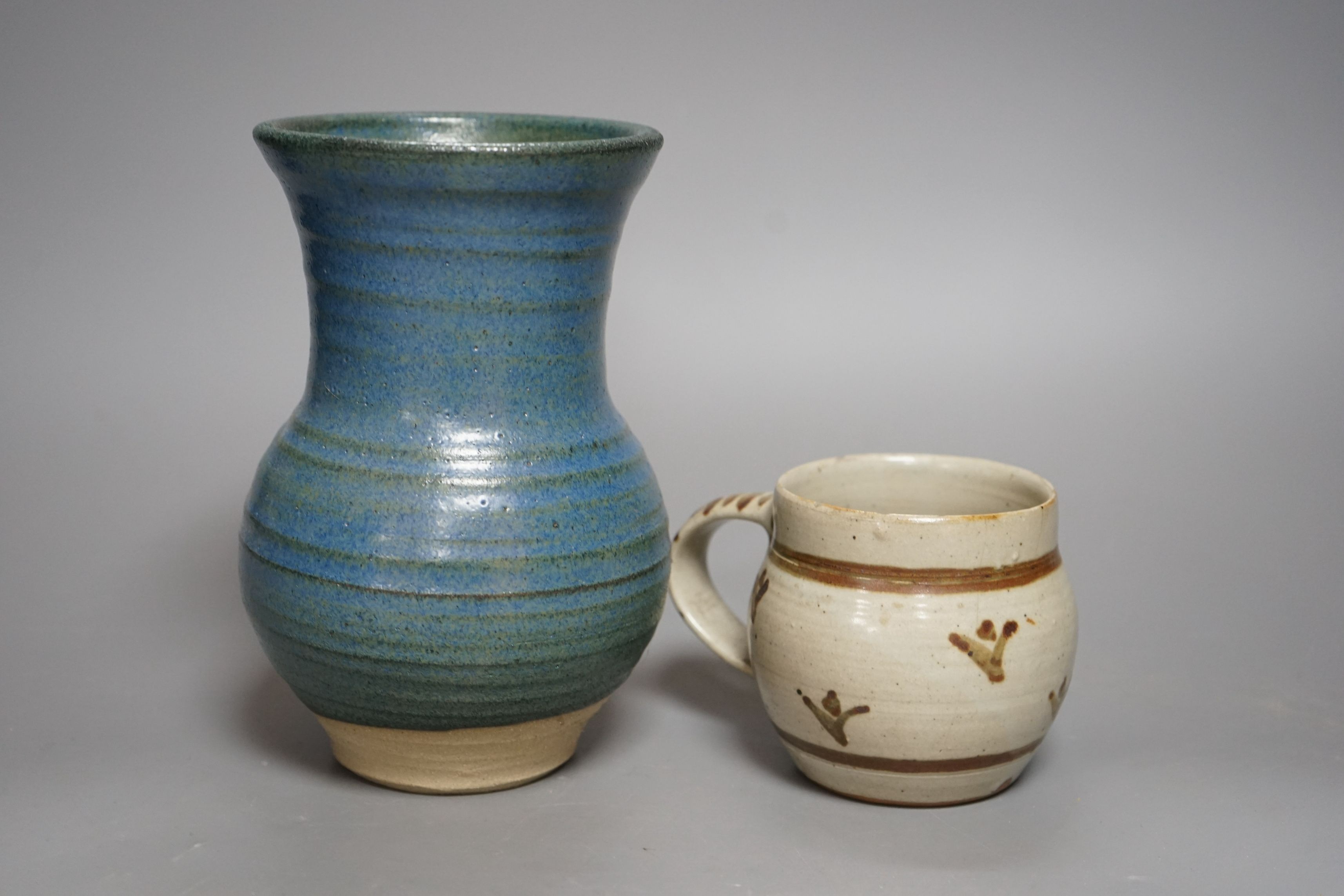 An Accolay style blue glazed stripe vase, together with a Wenford Bridge stoneware mug, both with impressed marks, tallest 19cm, (2)